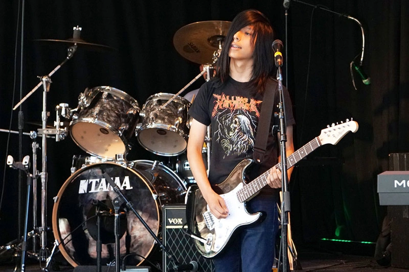 Young Man Playing Guitar Live